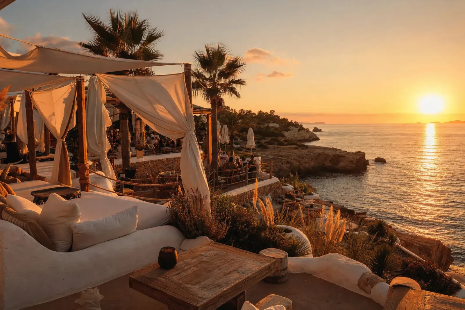 Ibiza beach club sunset terrace with white daybeds facing the Mediterranean