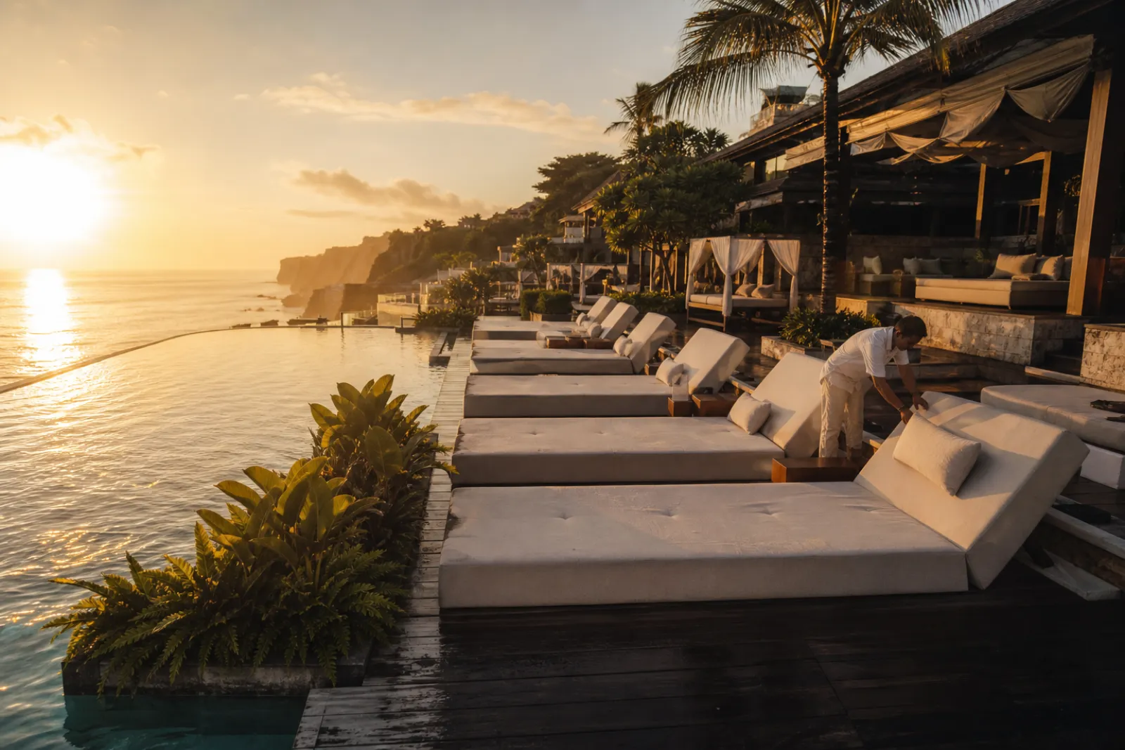 Operator comparing venue booking platforms on a laptop overlooking a beach club