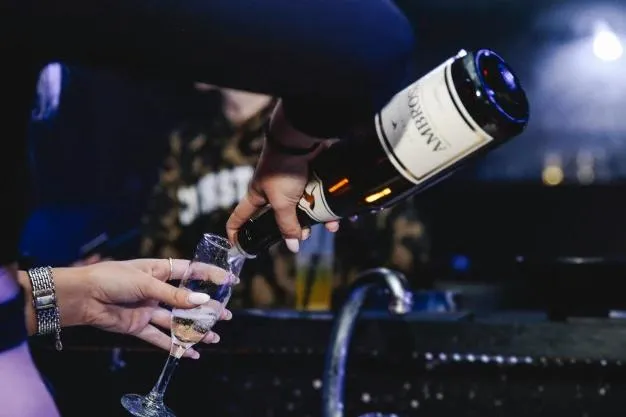 Champagne being poured as part of a beach club package