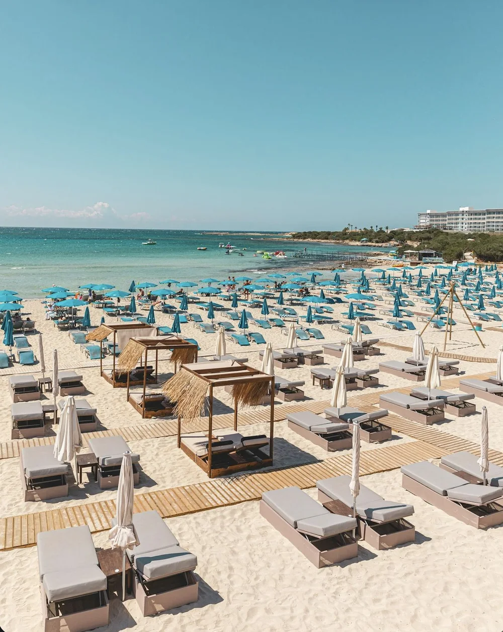 lasmari beach bar on the Cyprus coastline — daybeds, cabanas, and sunbeds on white sand