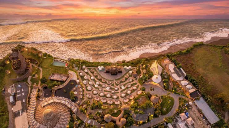 Luna Beach Club from above at sunset — the amphitheatre of daybeds on the Bali coastline